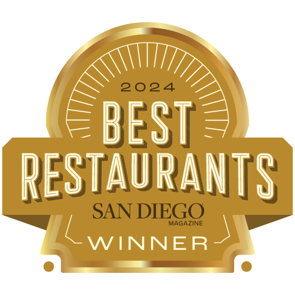 An emblem displaying "2024 Best Restaurants San Diego Magazine Winner" in gold with a decorative design.