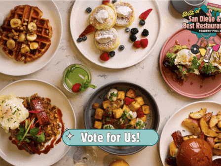 A spread of varied brunch foods: waffles, pastries, bowls, tacos, fried items, sauces, and a &ldquo;Vote for Us!&rdquo; badge in the center.